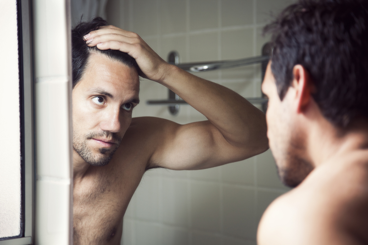 man examining hairline